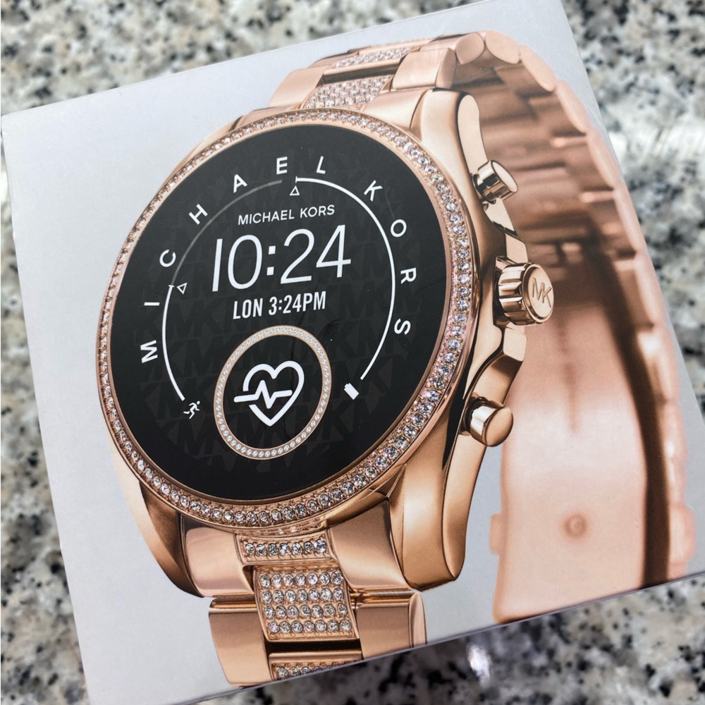 Michael Kors Smartwatch Rose gold with clear crystals metal band.